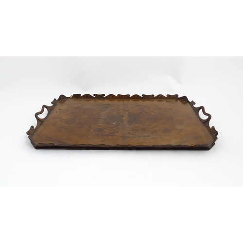 1300 - A 19thC yew wood tray of rectangular form with shaped gallery. Together with another of octagonal fo... 