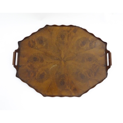 1300 - A 19thC yew wood tray of rectangular form with shaped gallery. Together with another of octagonal fo... 