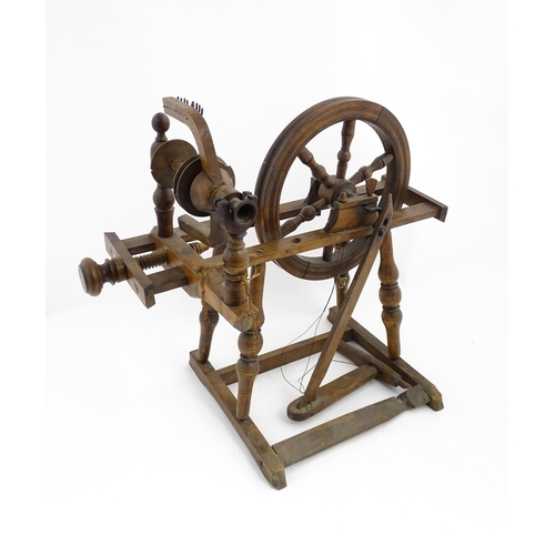 1301 - Treen : A Victorian turned wooden wool spinning wheel with a central six spoke wheel, and a foot ped... 