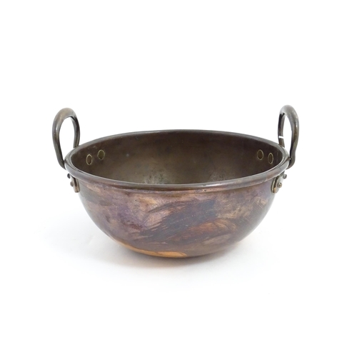 1310 - A 19thC copper confectioners bowl with twin handles. Approx. 13