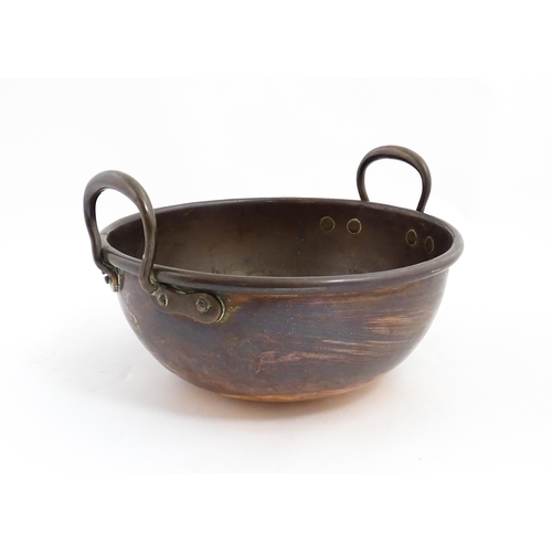 1310 - A 19thC copper confectioners bowl with twin handles. Approx. 13