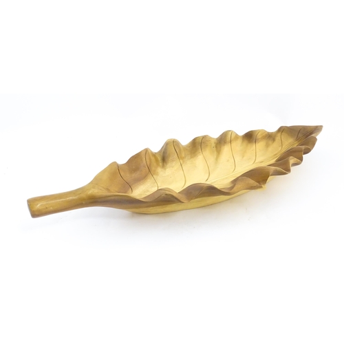 1311 - A 20thC carved wooden dish modelled as a stylised leaf. Approx. 30