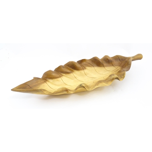 1311 - A 20thC carved wooden dish modelled as a stylised leaf. Approx. 30