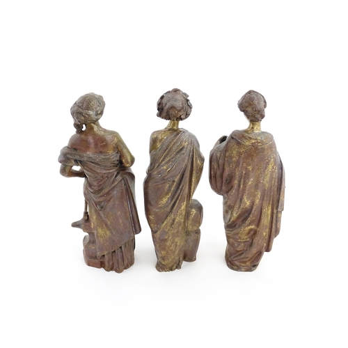 1313 - Three 19thC cast bronze sculptures depicting Classical maidens to include one standing before an anv... 