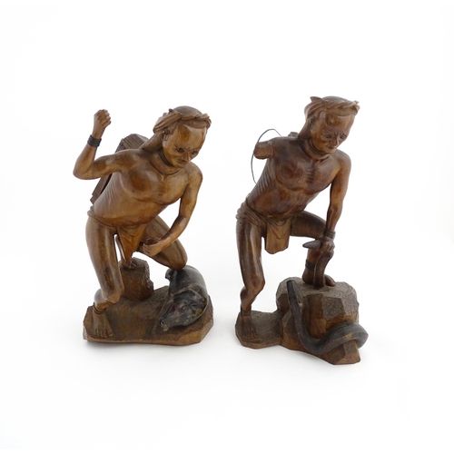 1314 - Two Asian carved warrior figures, one with a boar, the other with a serpent. Largest approx. 19 1/2