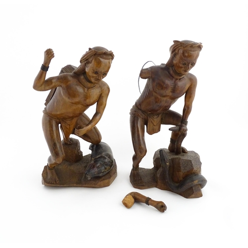 1314 - Two Asian carved warrior figures, one with a boar, the other with a serpent. Largest approx. 19 1/2