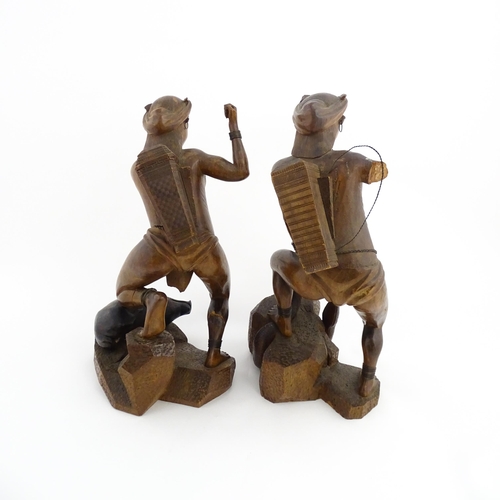 1314 - Two Asian carved warrior figures, one with a boar, the other with a serpent. Largest approx. 19 1/2