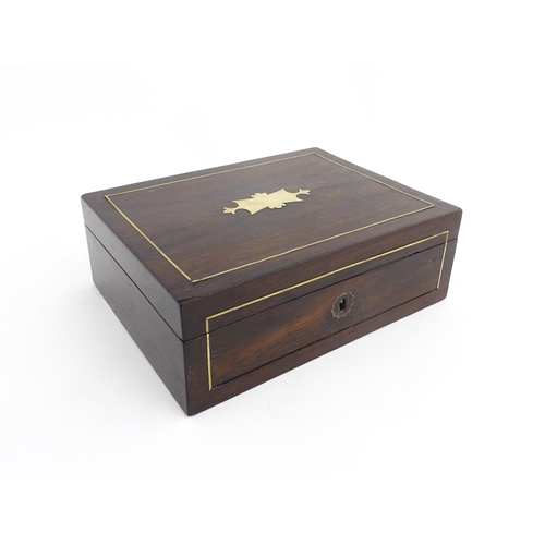 1319 - An early 20thC rosewood box with brass stringing and shaped plaque to top. Approx. 3 1/2