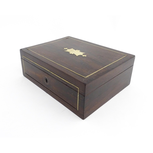 1319 - An early 20thC rosewood box with brass stringing and shaped plaque to top. Approx. 3 1/2