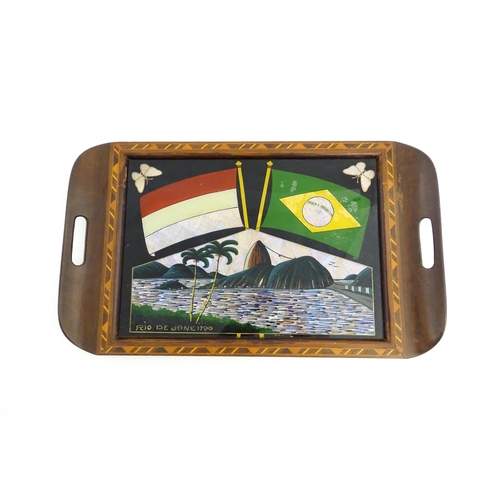 1320 - A 20thC Brazilian twin handled tray set with central scene depicting a Rio de Janeiro view with butt... 