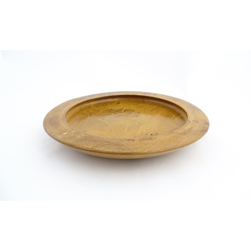 1321 - Treen : A 20thC turned oak dish of circular form. Approx. 16