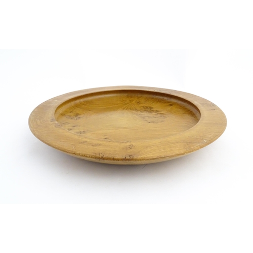 1321 - Treen : A 20thC turned oak dish of circular form. Approx. 16