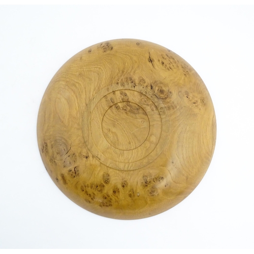 1321 - Treen : A 20thC turned oak dish of circular form. Approx. 16