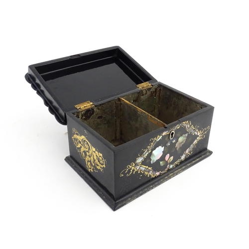 1328 - A Victorian lacquered papier mache tea caddy with abalone inlay and gilt scrolling detail. Opening t... 