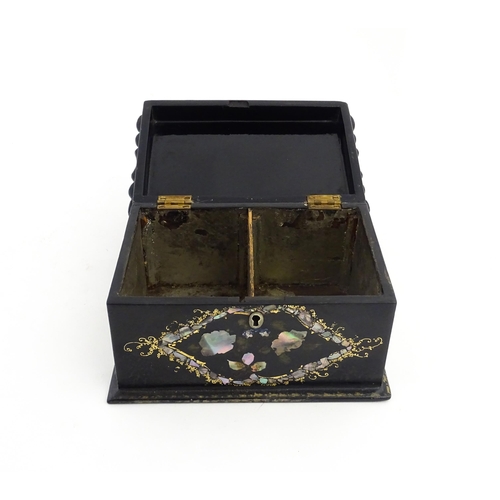 1328 - A Victorian lacquered papier mache tea caddy with abalone inlay and gilt scrolling detail. Opening t... 