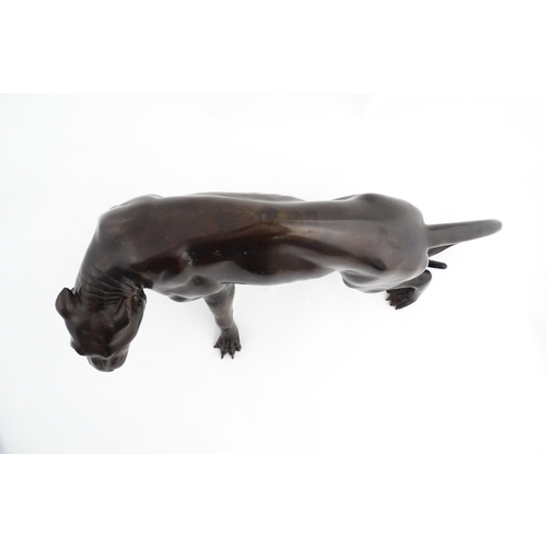 1333 - A 20thC cast bronze sculpture modelled as a panther / big cat. Approx. 13