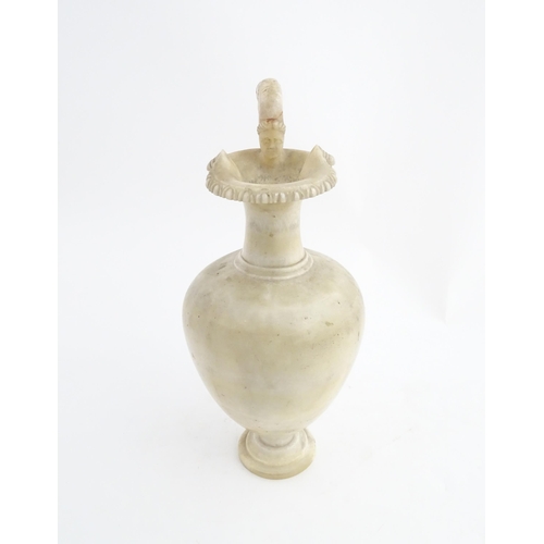 1334 - A carved alabaster ewer / jug in the Romanesque style. Approx. 18 1/2