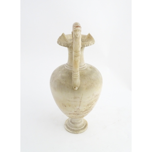 1334 - A carved alabaster ewer / jug in the Romanesque style. Approx. 18 1/2