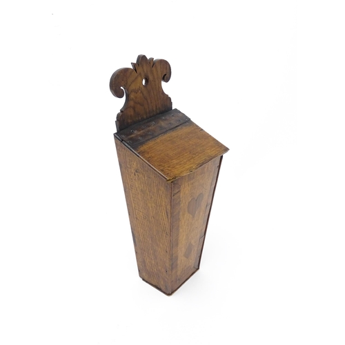 1341 - Treen : An early 19thC oak candle box of tapering form with shaped top, brass studded leather hinge,... 