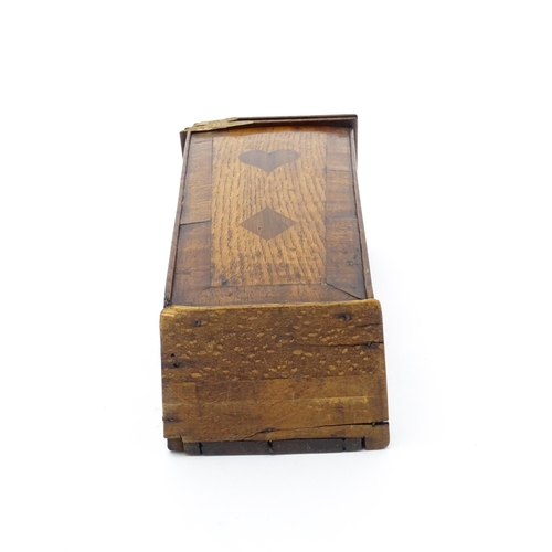 1341 - Treen : An early 19thC oak candle box of tapering form with shaped top, brass studded leather hinge,... 