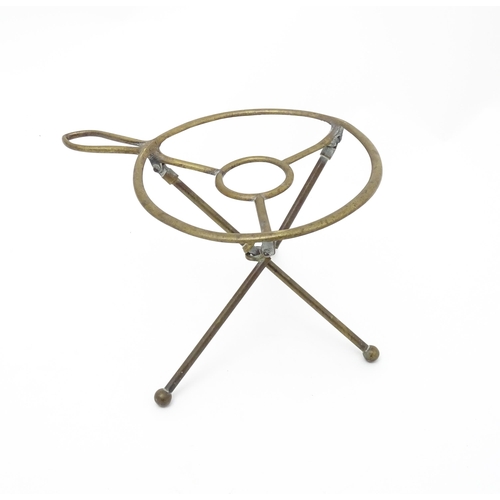 1344 - An early 20thC brass folding trivet with tripod base, stamped 'W T & S' (William Tonks & Sons) with ... 