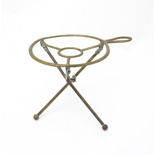 1344 - An early 20thC brass folding trivet with tripod base, stamped 'W T & S' (William Tonks & Sons) with ... 