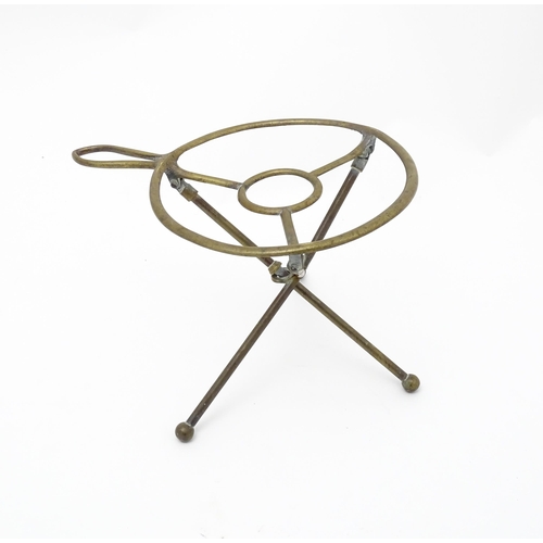 1344 - An early 20thC brass folding trivet with tripod base, stamped 'W T & S' (William Tonks & Sons) with ... 