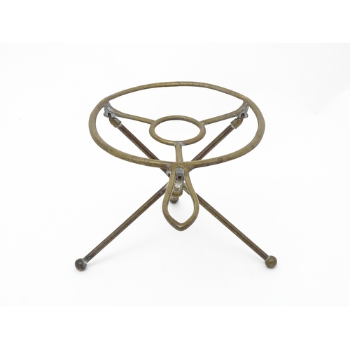 1344 - An early 20thC brass folding trivet with tripod base, stamped 'W T & S' (William Tonks & Sons) with ... 