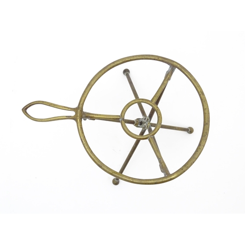 1344 - An early 20thC brass folding trivet with tripod base, stamped 'W T & S' (William Tonks & Sons) with ... 