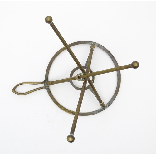 1344 - An early 20thC brass folding trivet with tripod base, stamped 'W T & S' (William Tonks & Sons) with ... 