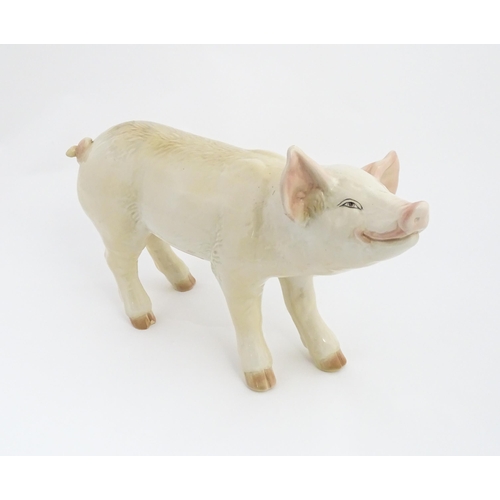 1347 - A 20thC butcher's advertising ceramic model of a standing pig with painted features. Approx. 14 1/2