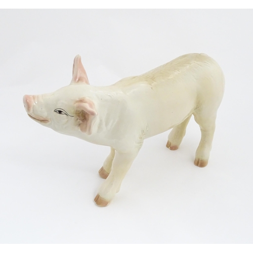 1347 - A 20thC butcher's advertising ceramic model of a standing pig with painted features. Approx. 14 1/2