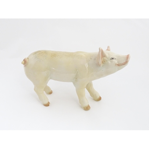 1347 - A 20thC butcher's advertising ceramic model of a standing pig with painted features. Approx. 14 1/2