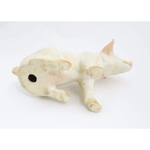 1348 - A 20thC butcher's advertising ceramic model of a seated pig with painted features. Approx. 12 1/4