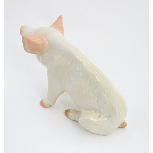 1348 - A 20thC butcher's advertising ceramic model of a seated pig with painted features. Approx. 12 1/4