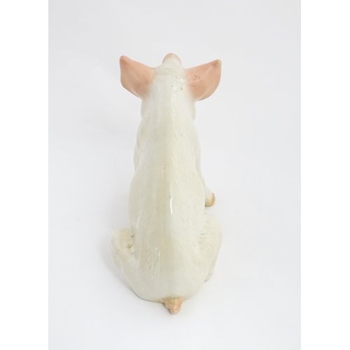 1348 - A 20thC butcher's advertising ceramic model of a seated pig with painted features. Approx. 12 1/4