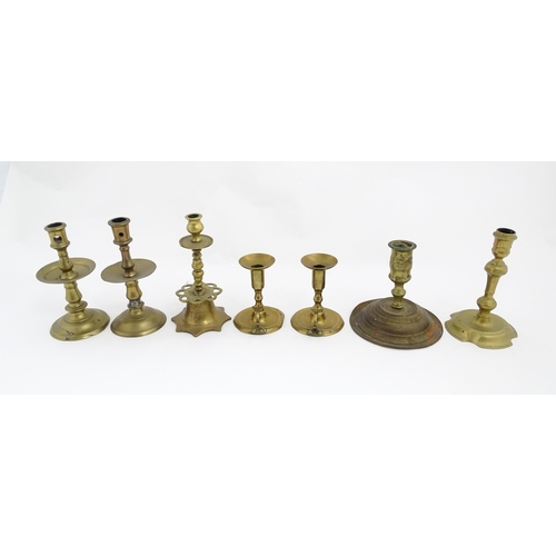 1350 - A quantity of 18thC and later brass wares to include candlesticks, mid drip candlesticks, a pair of ... 