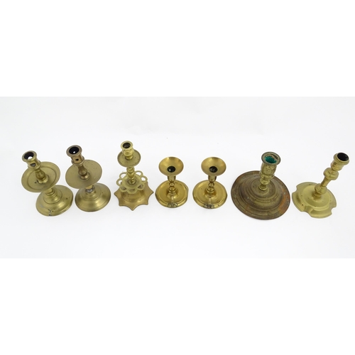 1350 - A quantity of 18thC and later brass wares to include candlesticks, mid drip candlesticks, a pair of ... 