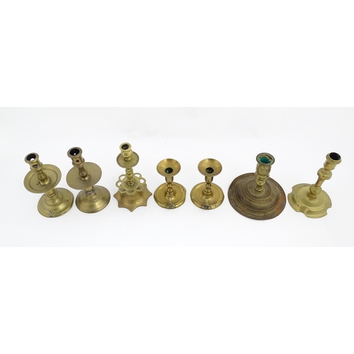 1350 - A quantity of 18thC and later brass wares to include candlesticks, mid drip candlesticks, a pair of ... 