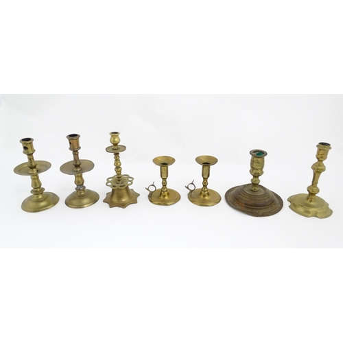 1350 - A quantity of 18thC and later brass wares to include candlesticks, mid drip candlesticks, a pair of ... 