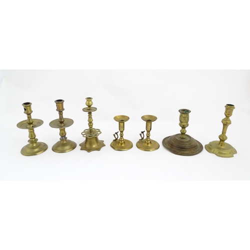 1350 - A quantity of 18thC and later brass wares to include candlesticks, mid drip candlesticks, a pair of ... 