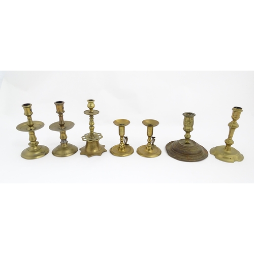 1350 - A quantity of 18thC and later brass wares to include candlesticks, mid drip candlesticks, a pair of ... 