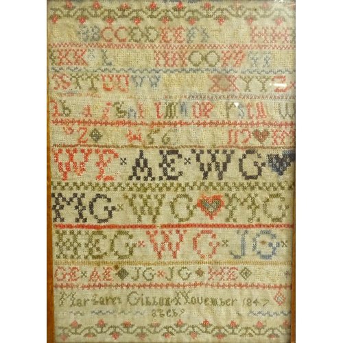 1382 - A 19thC needlework sampler with letters of the alphabet and foliate borders, by Margaret Gibbon, 184... 