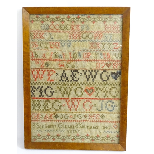 1382 - A 19thC needlework sampler with letters of the alphabet and foliate borders, by Margaret Gibbon, 184... 