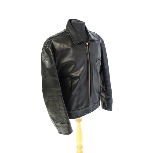 1393 - Vintage fashion / clothing: A black leather jacket by Skin Deep with zip fastening and zipped breast... 