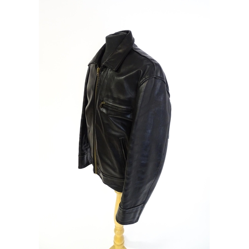 1393 - Vintage fashion / clothing: A black leather jacket by Skin Deep with zip fastening and zipped breast... 