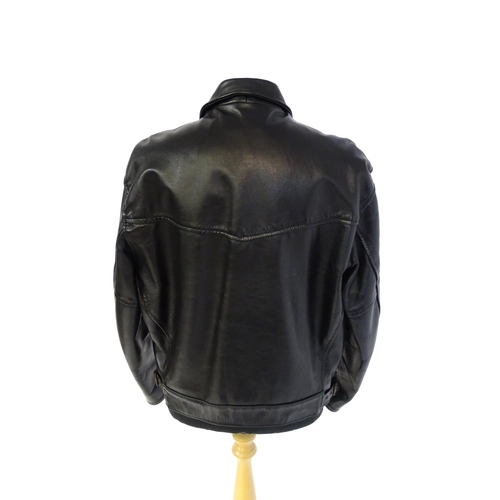 1393 - Vintage fashion / clothing: A black leather jacket by Skin Deep with zip fastening and zipped breast... 