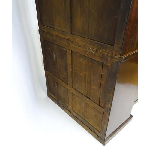 1558 - A late Georgian secretaire bookcase a carved scrolling pediment above two glazed doors. The long sec... 