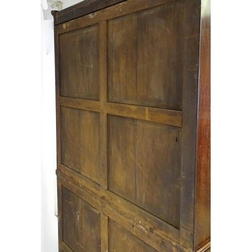 1558 - A late Georgian secretaire bookcase a carved scrolling pediment above two glazed doors. The long sec... 