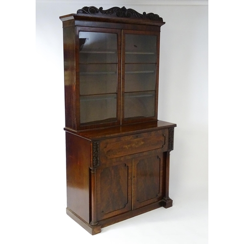 1558 - A late Georgian secretaire bookcase a carved scrolling pediment above two glazed doors. The long sec... 